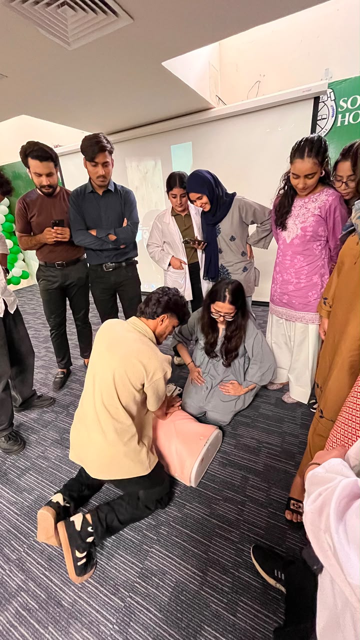 Students practising basic life support technique on a manikin