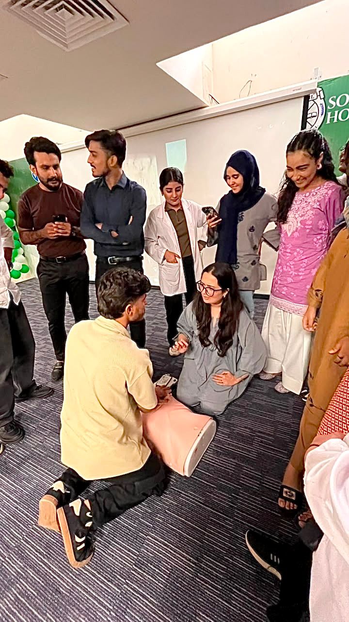 Medical students practising CPR on a manikin during a Revive Lives Basic Life Support workshop